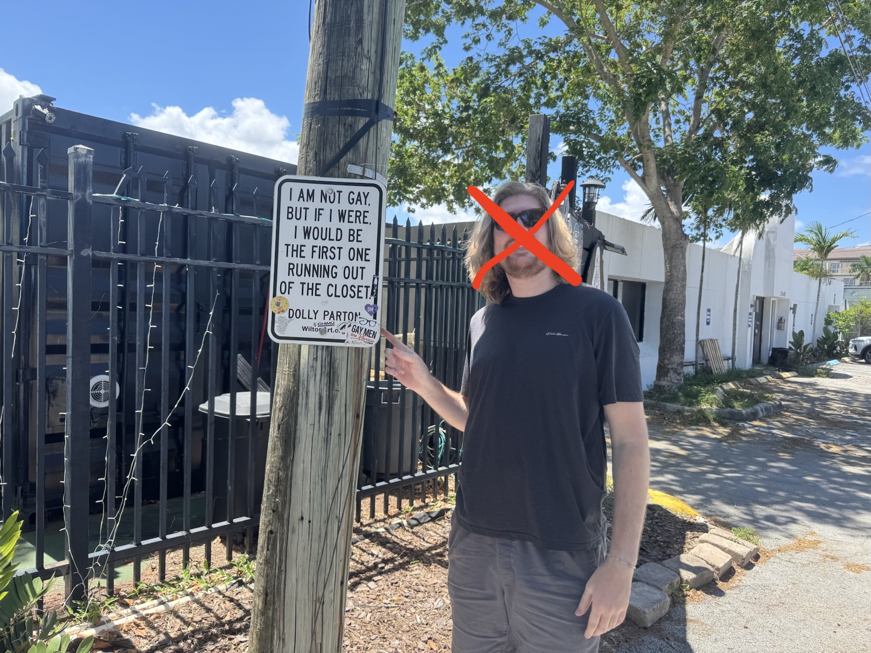 Exhibit C — Martin near a closet sign